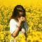 girl with hayfever in field of flowers