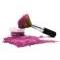 Rose-colored mineral makeup spilling out of the jar with kabuki brush