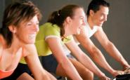 three people spinning in the gym