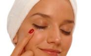 woman applying eye cream woman applying eye cream