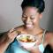 woman eating fresh fruit