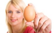 woman holding an egg woman holding an egg