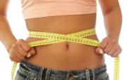 woman measuring waist with tape measure woman measuring waist with tape measure