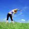 woman stretching in a field