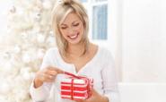 woman unwrapping Christmas gift