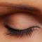 Woman's eye with long eyelashes and shaped eyebrow