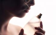 Blond woman with perfume bottle