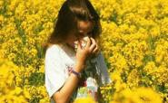 girl with hayfever in field of flowers