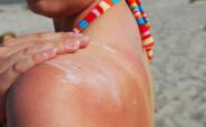 woman applying sunblock on the beach