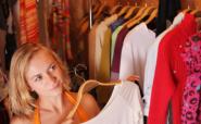 woman choosing from rack of clothes