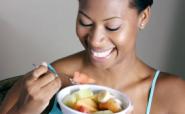 woman eating fresh fruit