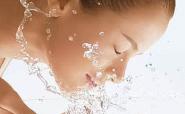 woman splashing her face with water