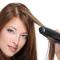 woman straightening hair with a flat iron