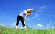 woman stretching in a field
